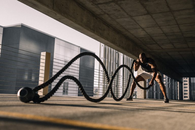 man working out with ropes