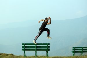 man jumping from bench