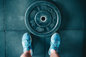 person standing next to weights